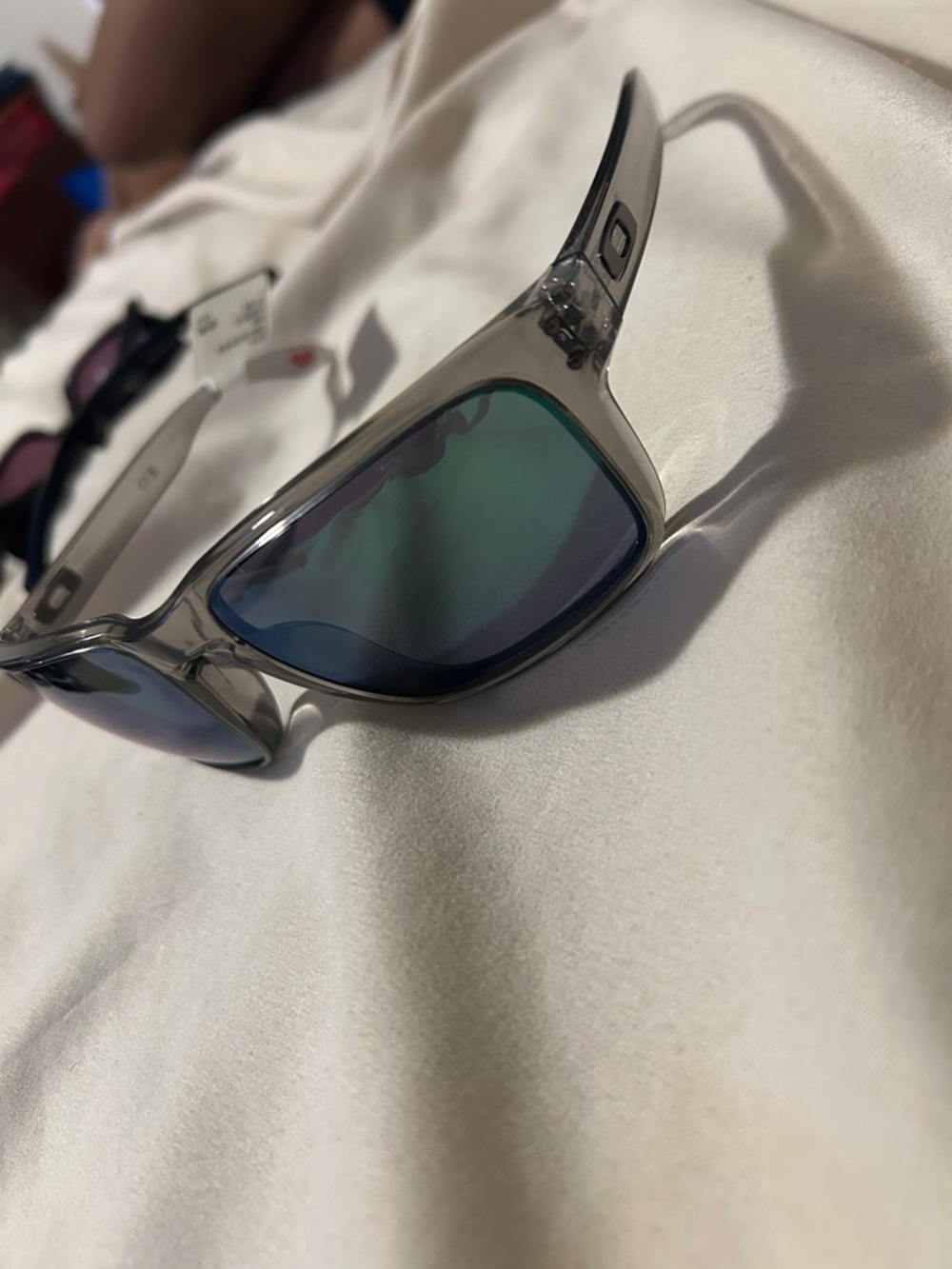 Oakley Clear Frame Sunglasses with Blue-Green Mirrored Lenses